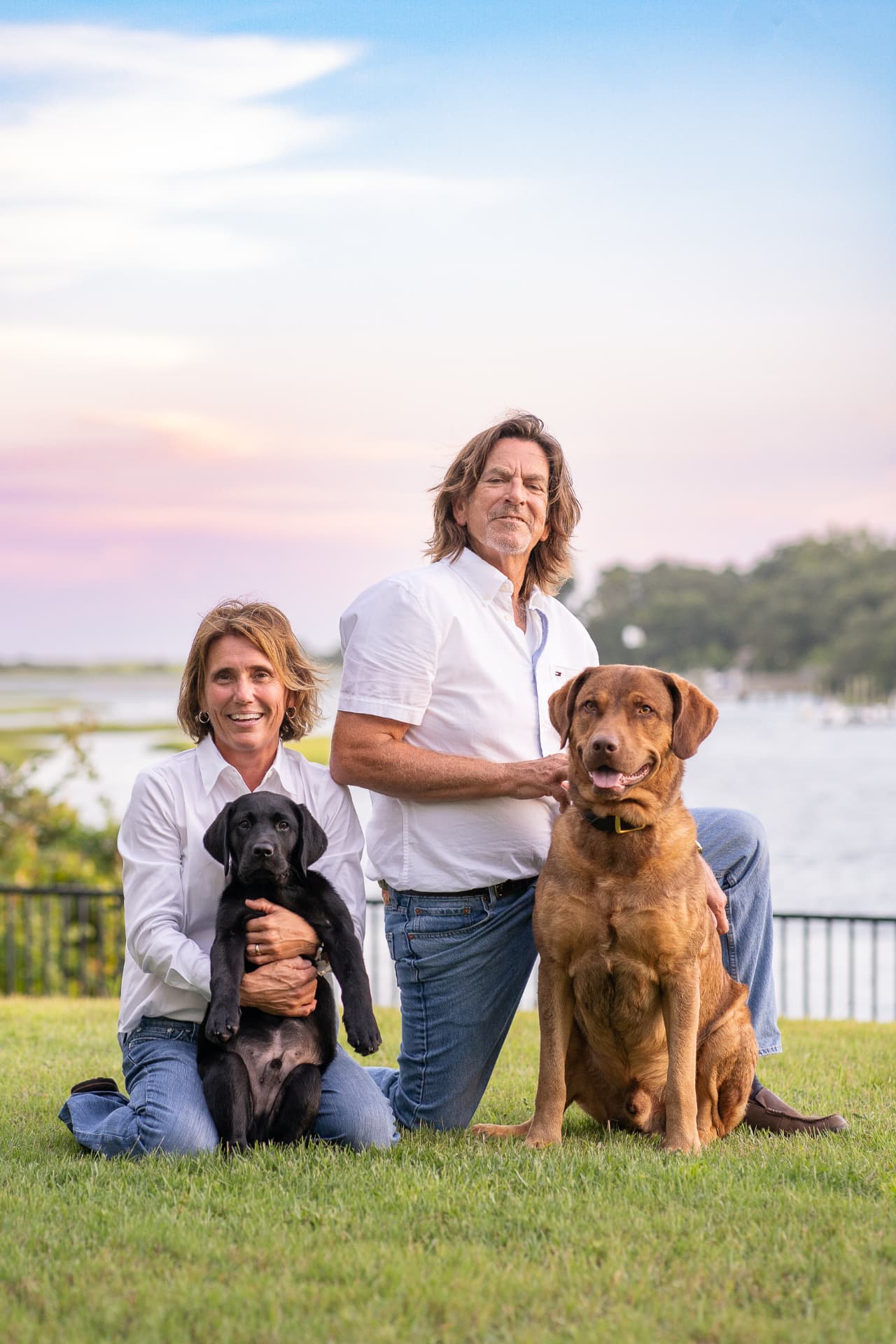 Family portrait with two dogs by the water